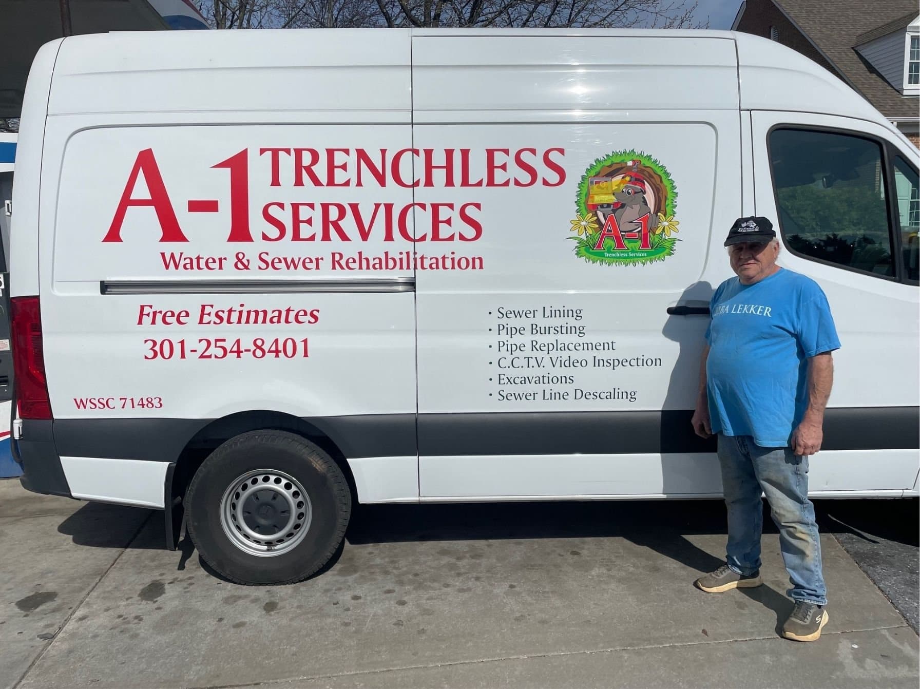 A-1 Trenchless team member standing beside the white A-1 Trenchless Services van on a driveway